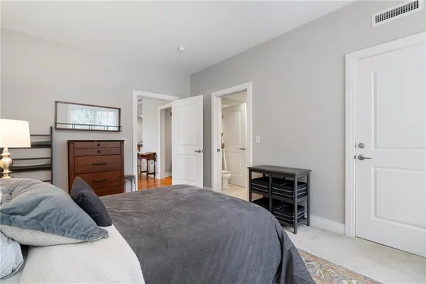 a bedroom with a bed and dresser