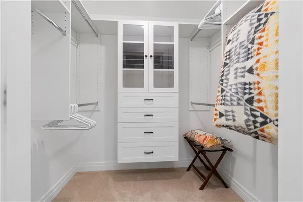 a view of an empty room with cabinet and a window