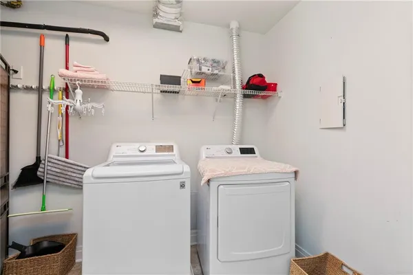 a view of storage and utility room with washer and dryer