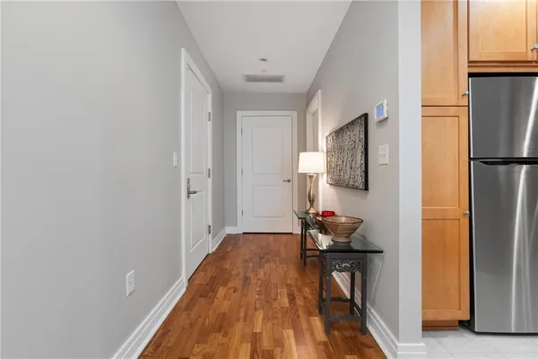 a hallway with furniture and wooden floor
