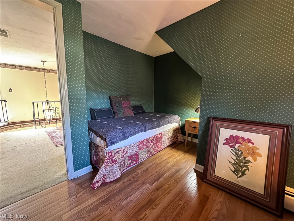 11911 County Line Road Chesterland, OH 44026 - Photo 28 of 49 Bedroom with carpet floors, a baseboard heating unit, and a chandelier