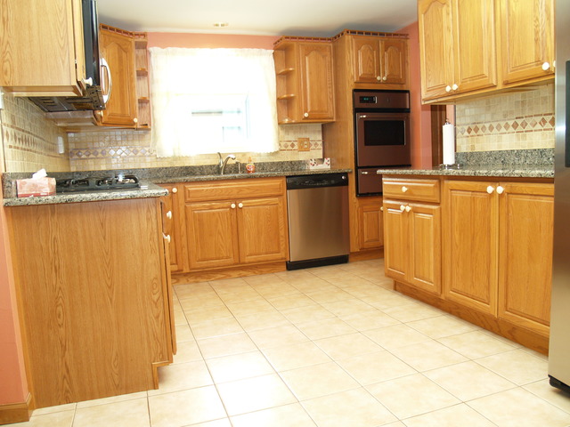 457 Rockhurst Road Bolingbrook, IL 60440 - Photo 2 of 24 a kitchen with stainless steel appliances granite countertop a stove a sink and a microwave