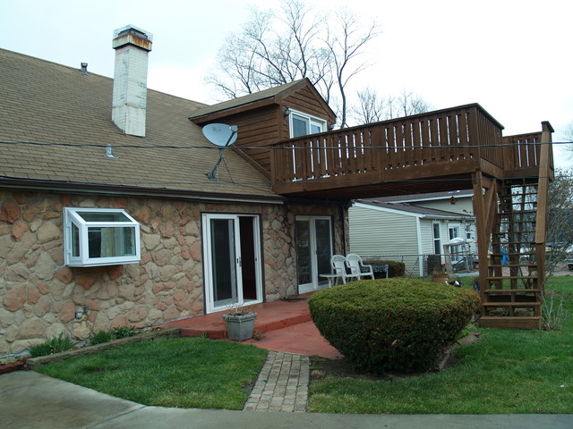 457 Rockhurst Road Bolingbrook, IL 60440 - Photo 23 of 24 a view of a house with brick walls and a yard with plants
