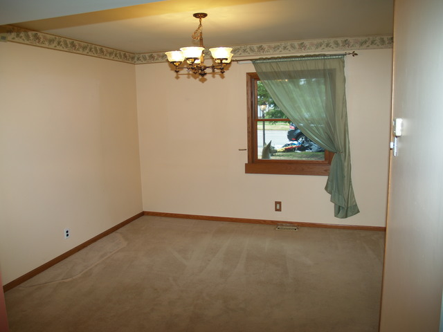 457 Rockhurst Road Bolingbrook, IL 60440 - Photo 5 of 24 en empty room with window and wooden floor