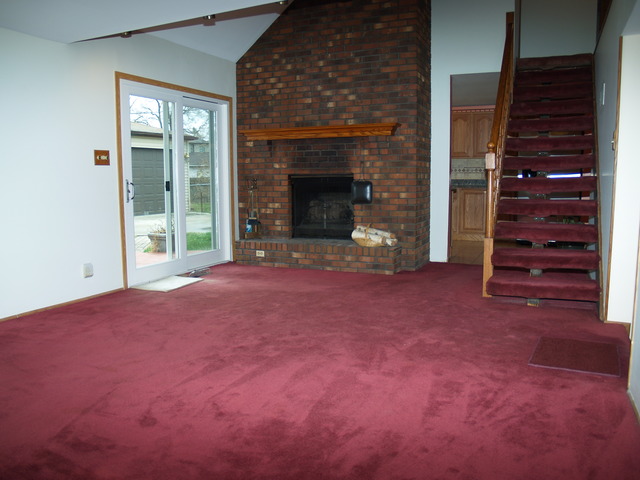 457 Rockhurst Road Bolingbrook, IL 60440 - Photo 7 of 24 a view of an empty room with a fireplace and window