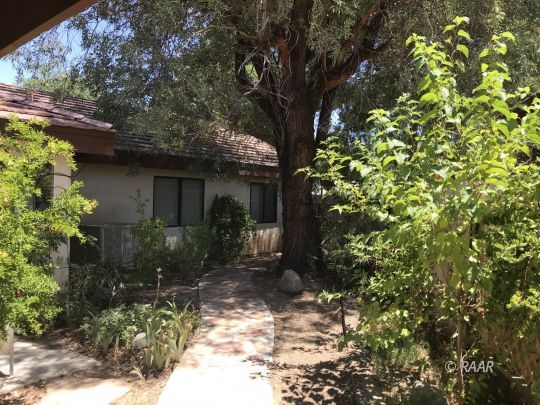 1009 Meadowview Lane Ridgecrest, CA 93555 - Photo 30 of 32 a front view of a house with a yard
