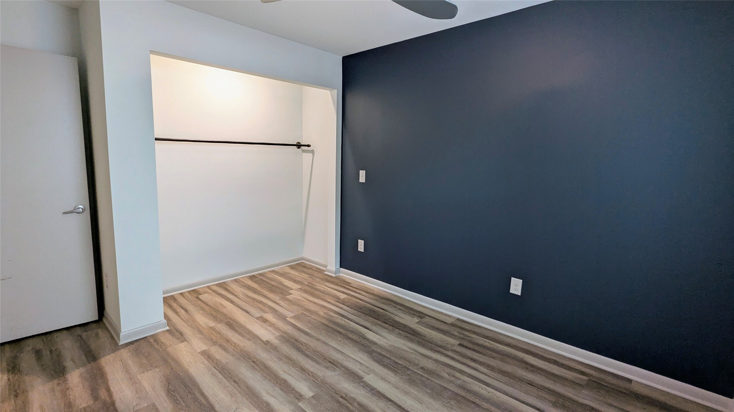 4505 Teri Road, Unit A Austin, TX 78744 - Photo 16 of 23 A streamlined bedroom space features light wood-look flooring and a built-in closet area, offering practical living.