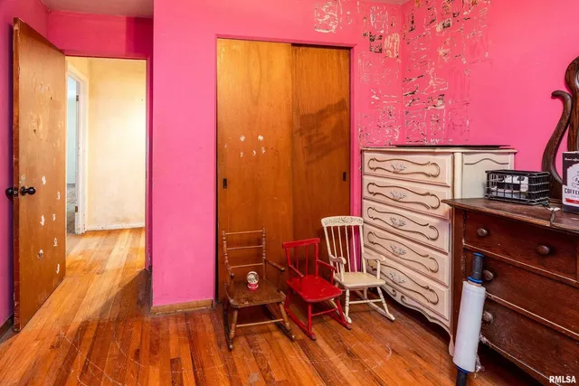 a view of a room with wooden floor and brick walls