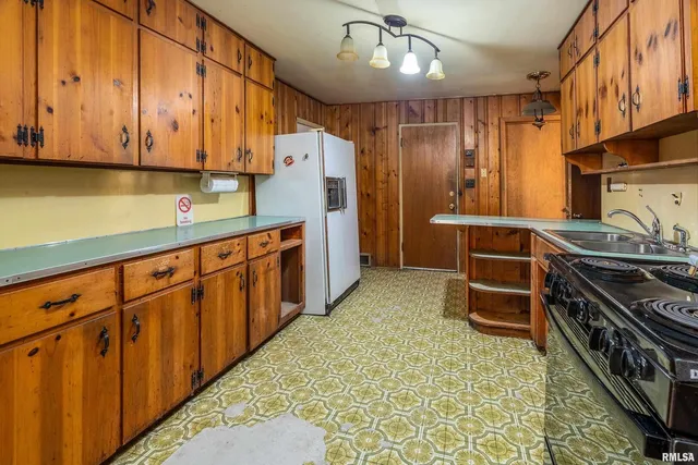 a kitchen with stainless steel appliances a stove a refrigerator and cabinets