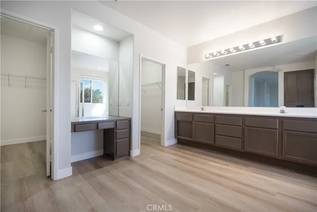 a spacious bathroom with a granite countertop sink mirror and cabinets