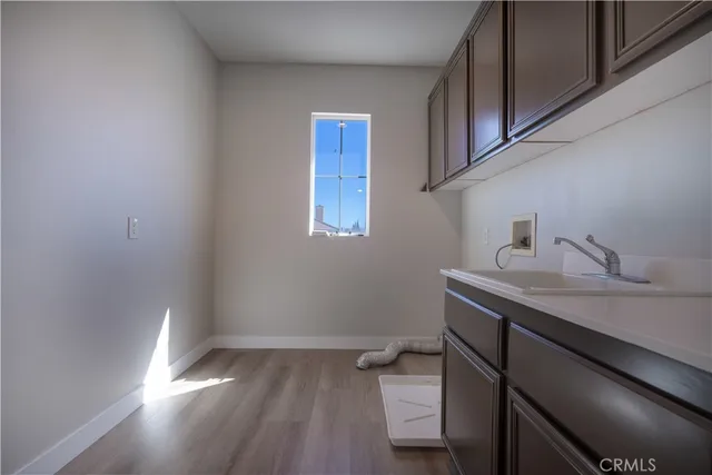a view of a room with wooden floor and cabinets