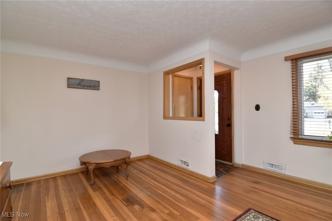38535 Aurora Road Solon, OH 44139 - Photo 5 of 26 Unfurnished room featuring a textured ceiling and hardwood / wood-style flooring
