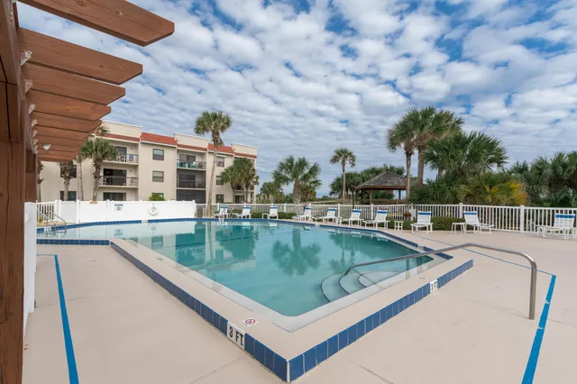 a view of house with yard and potted plants