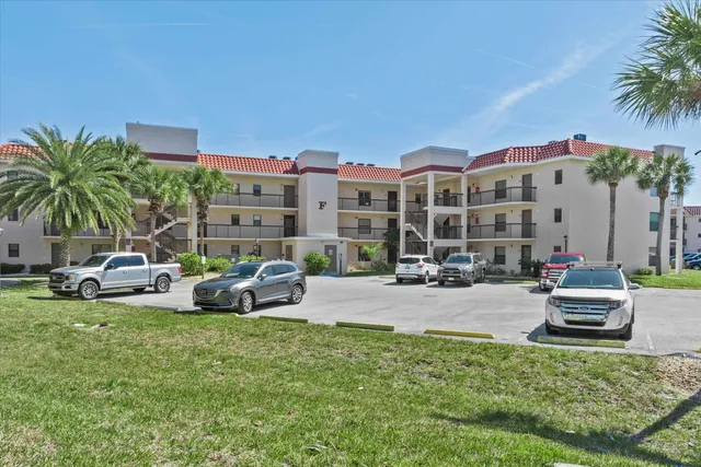a couple of cars parked in front of a house