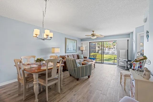 a view of a livingroom with furniture window and wooden floor