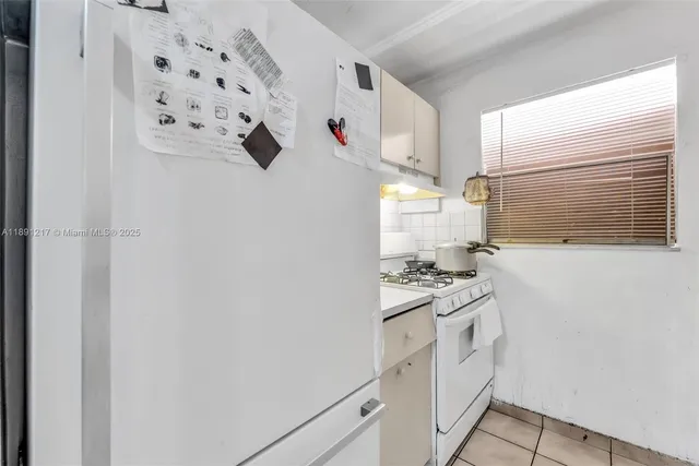a kitchen with white cabinets and white appliances