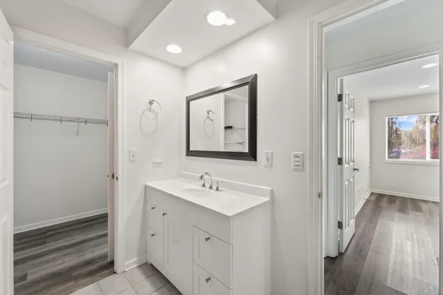 a bathroom with a sink mirror and shower