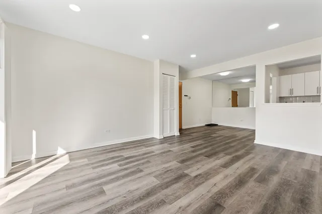 a view of a kitchen with a sink and a refrigerator