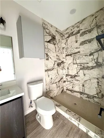a white toilet sitting next to a shower curtain