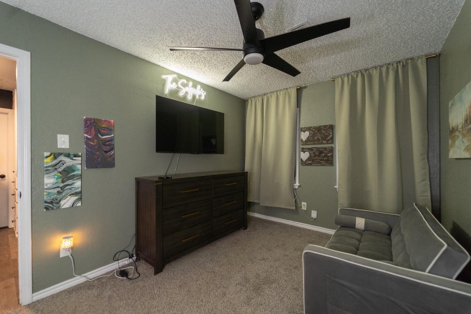 1517 41st Street Lubbock, TX 79412 - Photo 18 of 22 a room with furniture and a flat screen tv