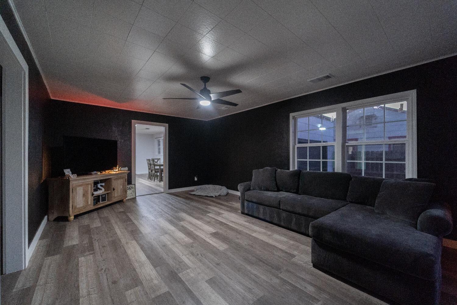 1517 41st Street Lubbock, TX 79412 - Photo 2 of 22 a living room with furniture and a flat screen tv