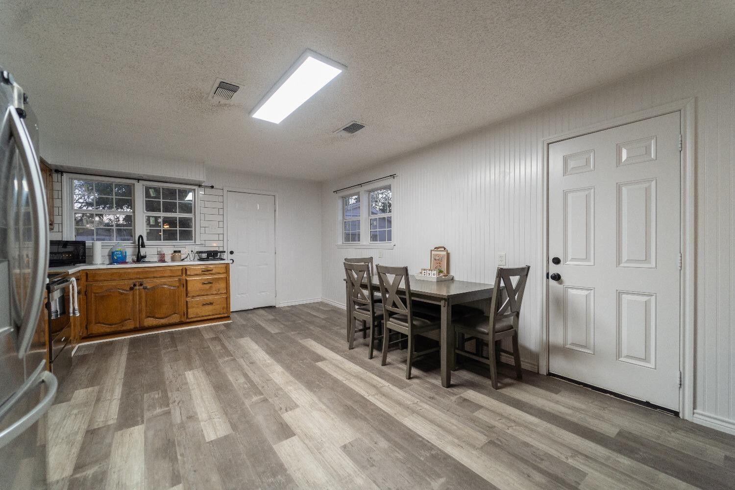1517 41st Street Lubbock, TX 79412 - Photo 7 of 22 a view of a dining room with furniture and chandelier