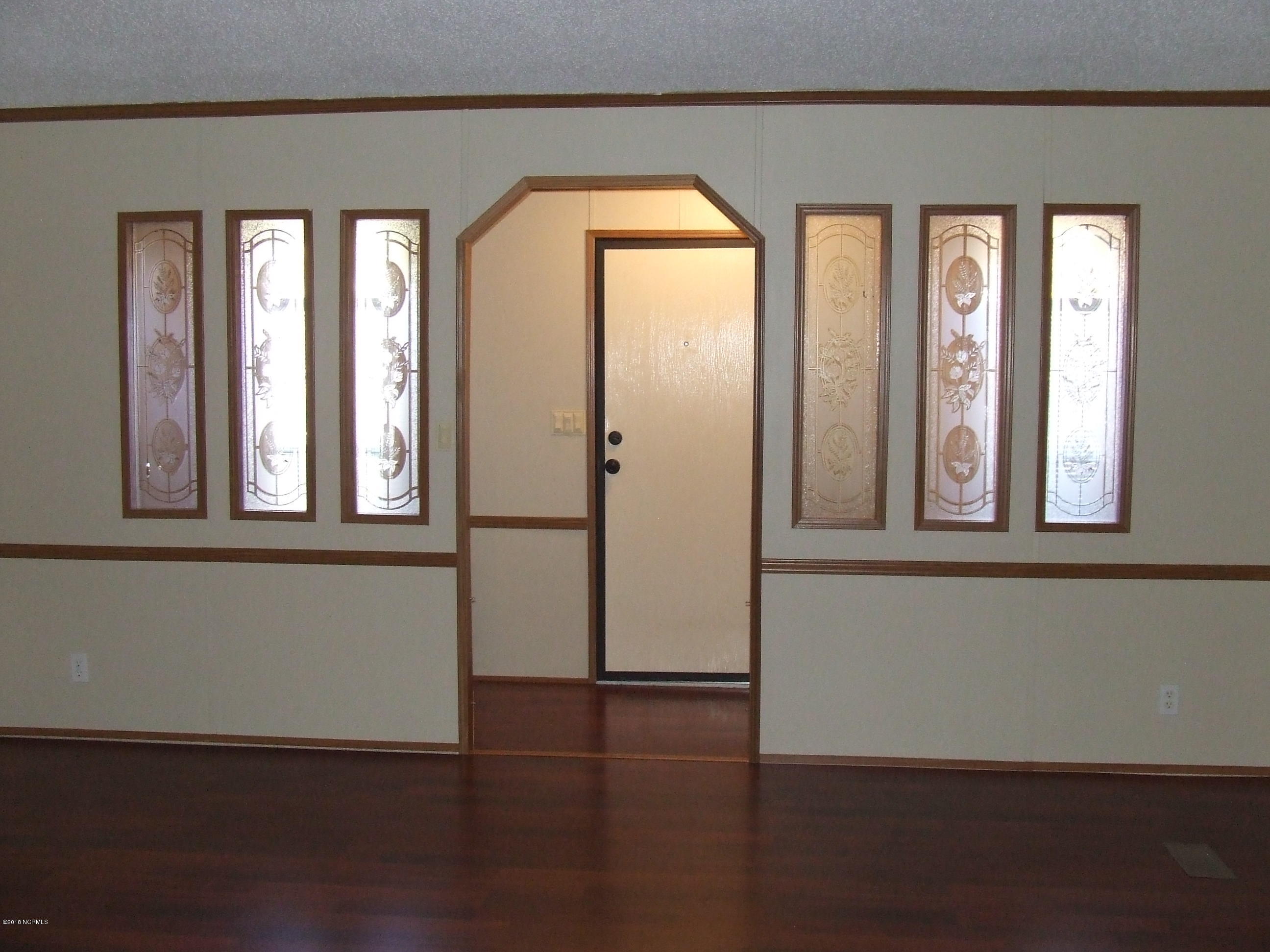 VIEW OF FRONT DOOR AND HALLWAY