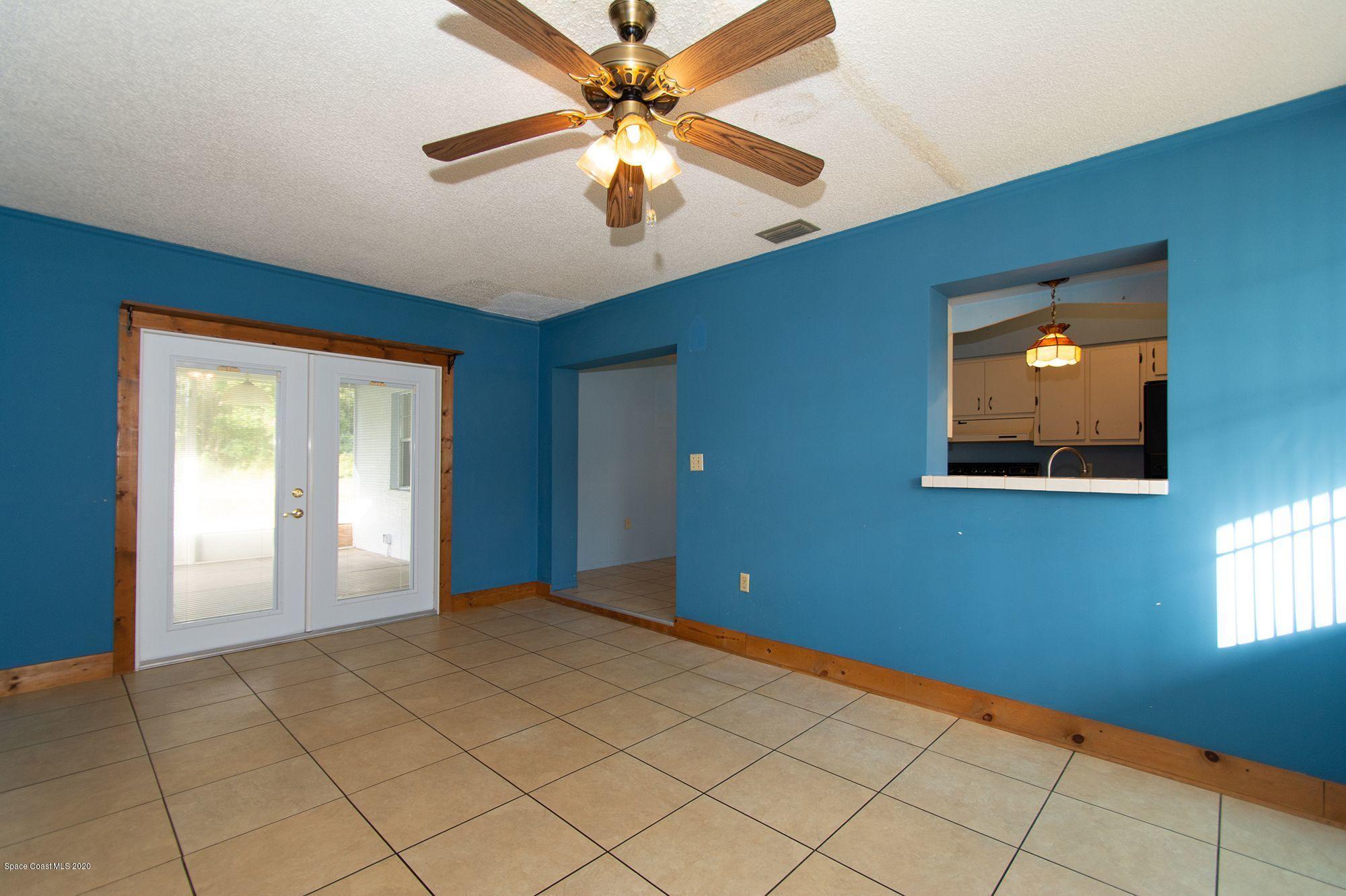 2872 Pembroke Road Melbourne, FL 32935 - Photo 16 of 32 a view of an empty room with window and chandelier fan