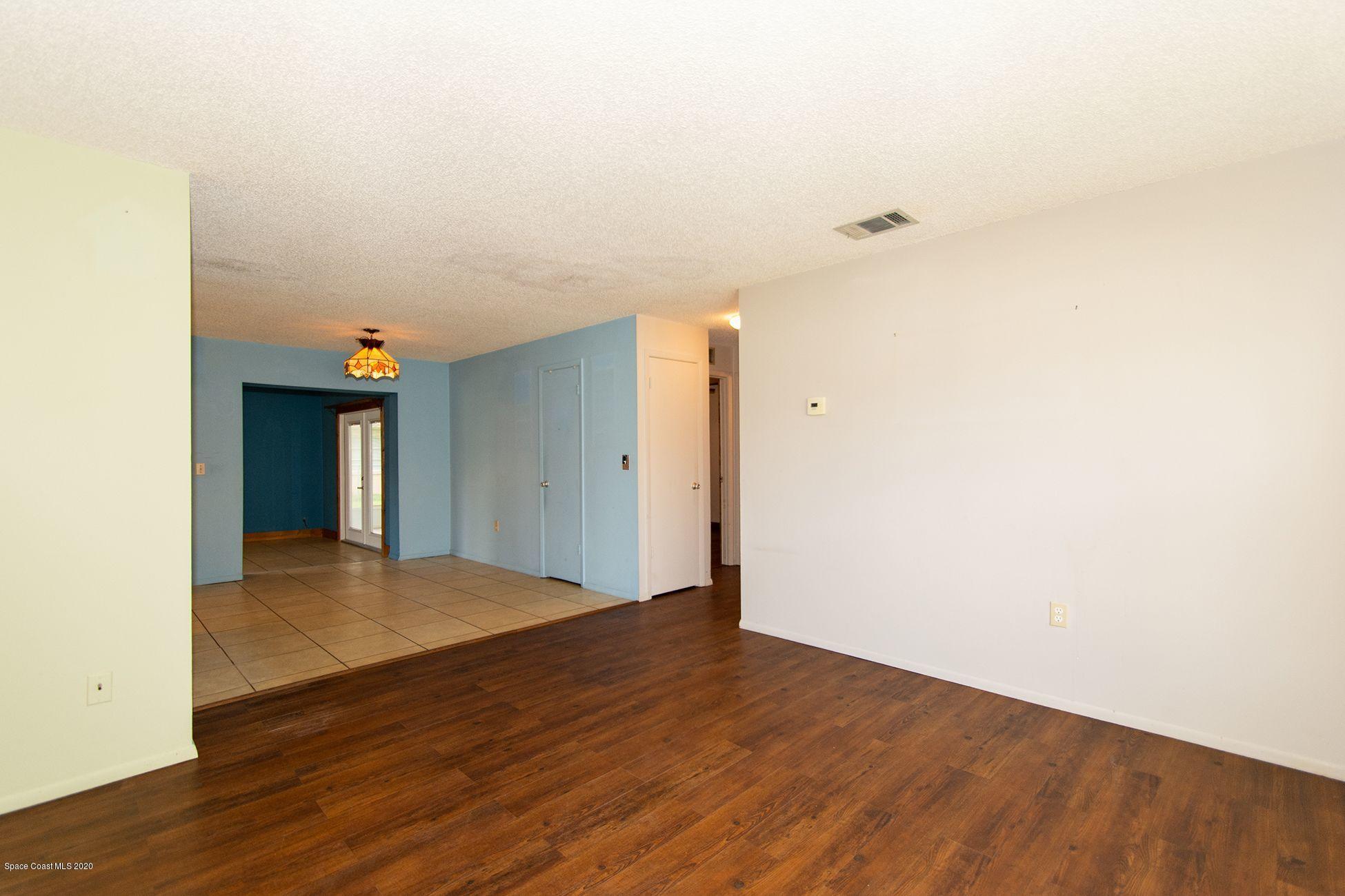 2872 Pembroke Road Melbourne, FL 32935 - Photo 17 of 32 a view of an empty room with wooden floor
