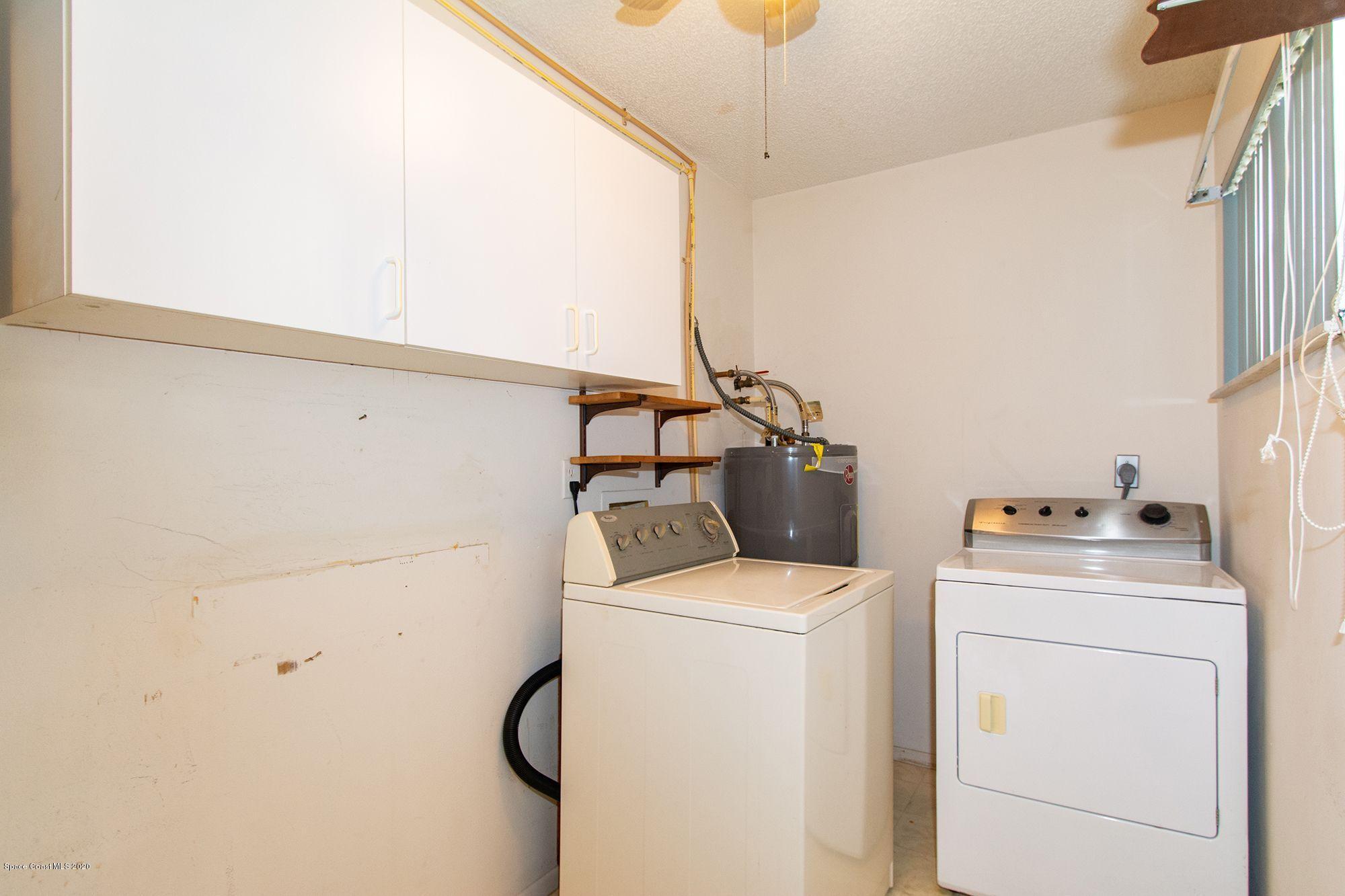 2872 Pembroke Road Melbourne, FL 32935 - Photo 23 of 32 a utility room with dryer and washer