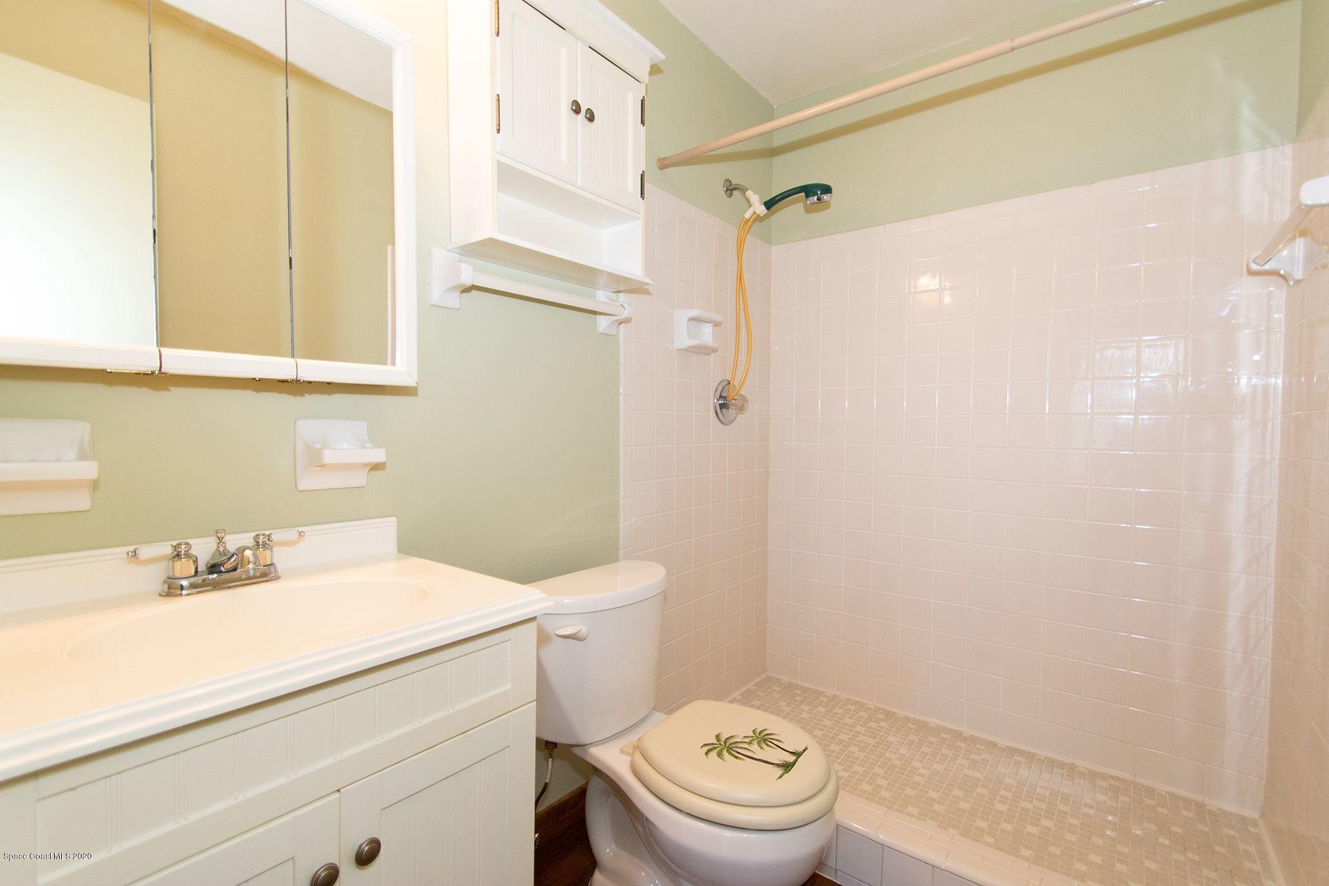 2872 Pembroke Road Melbourne, FL 32935 - Photo 24 of 32 a bathroom with a sink a toilet and shower