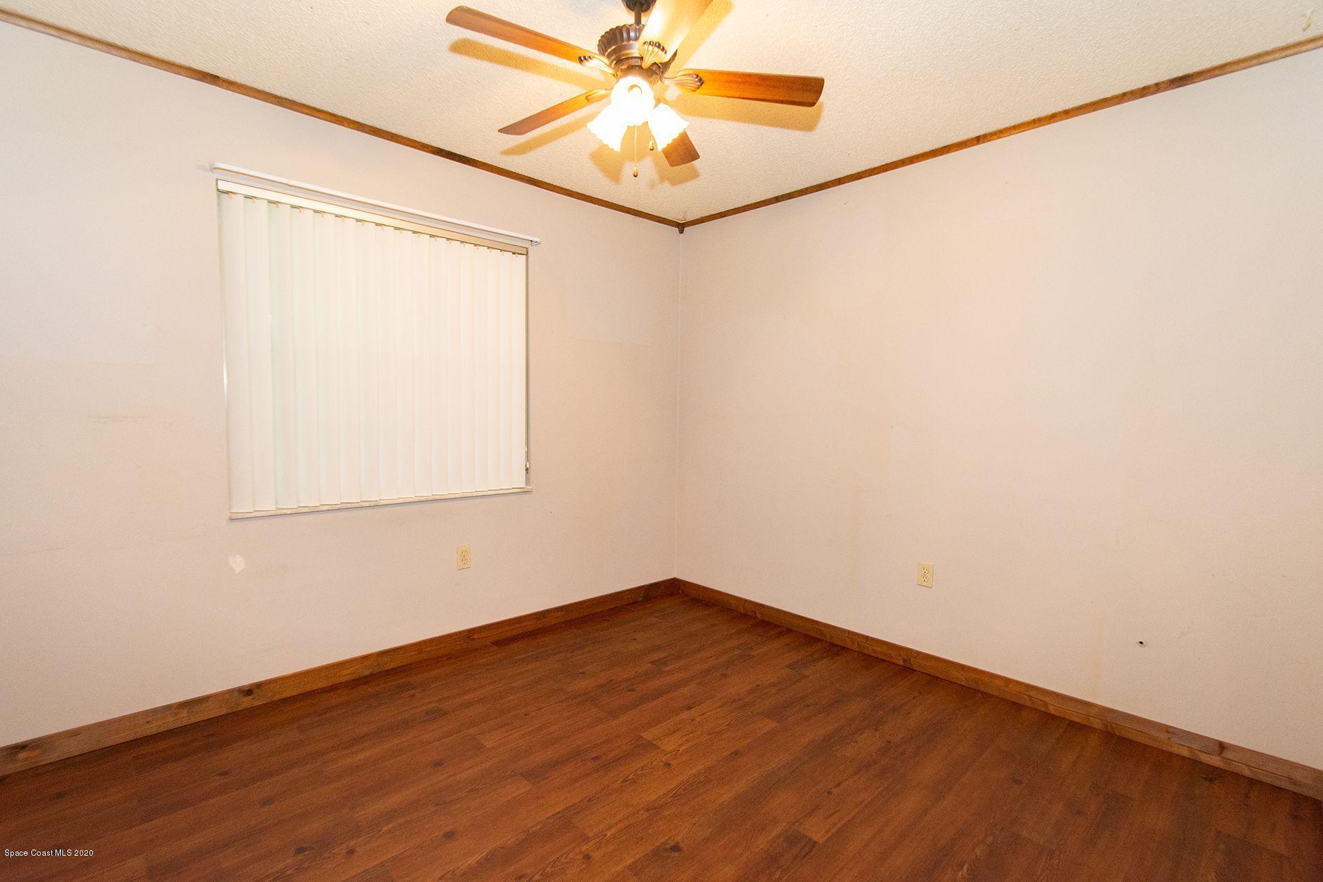 2872 Pembroke Road Melbourne, FL 32935 - Photo 26 of 32 an empty room with a window and a fan