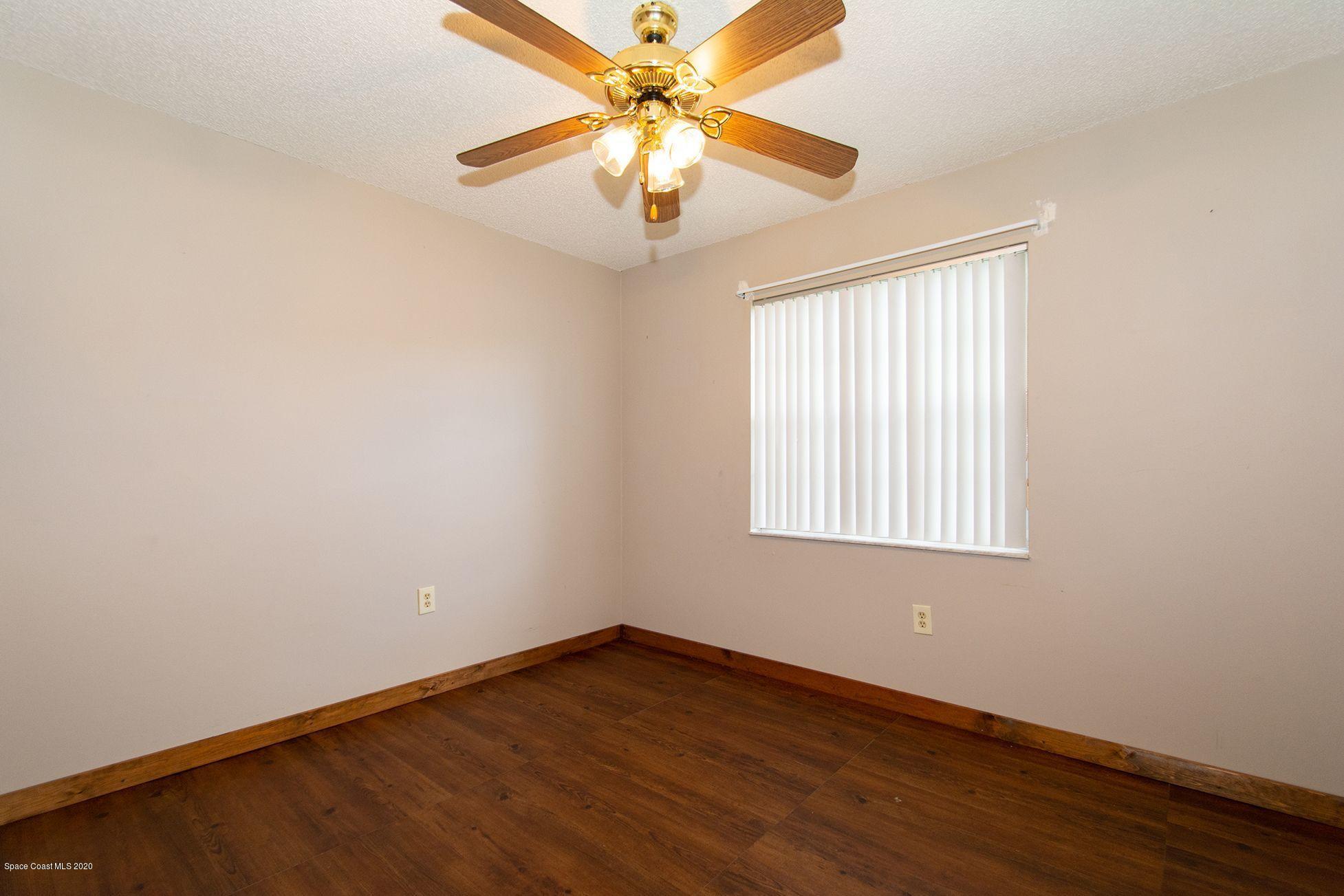 2872 Pembroke Road Melbourne, FL 32935 - Photo 29 of 32 an empty room with a window and a fan
