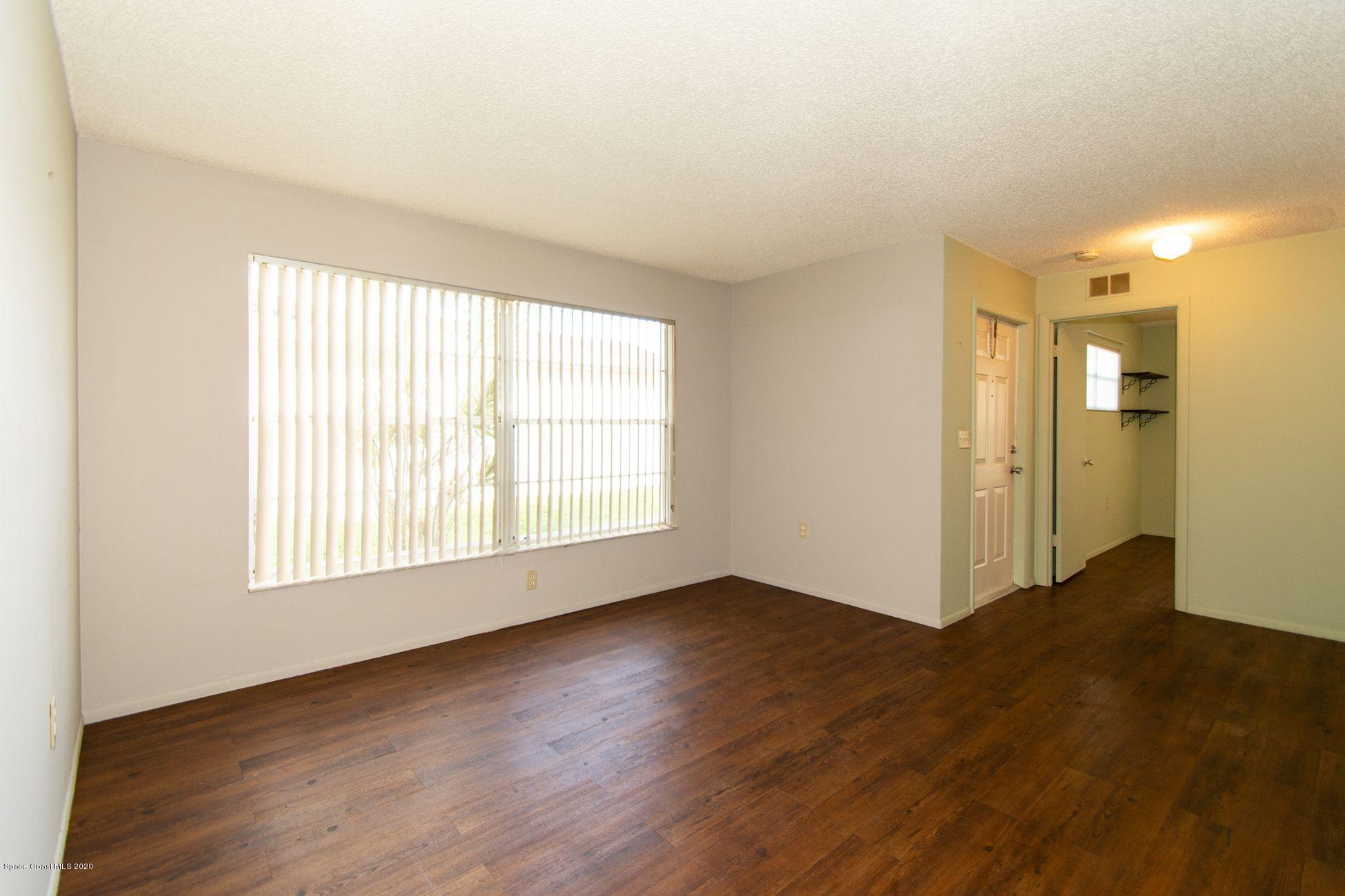 2872 Pembroke Road Melbourne, FL 32935 - Photo 6 of 32 an empty room with wooden floor and windows