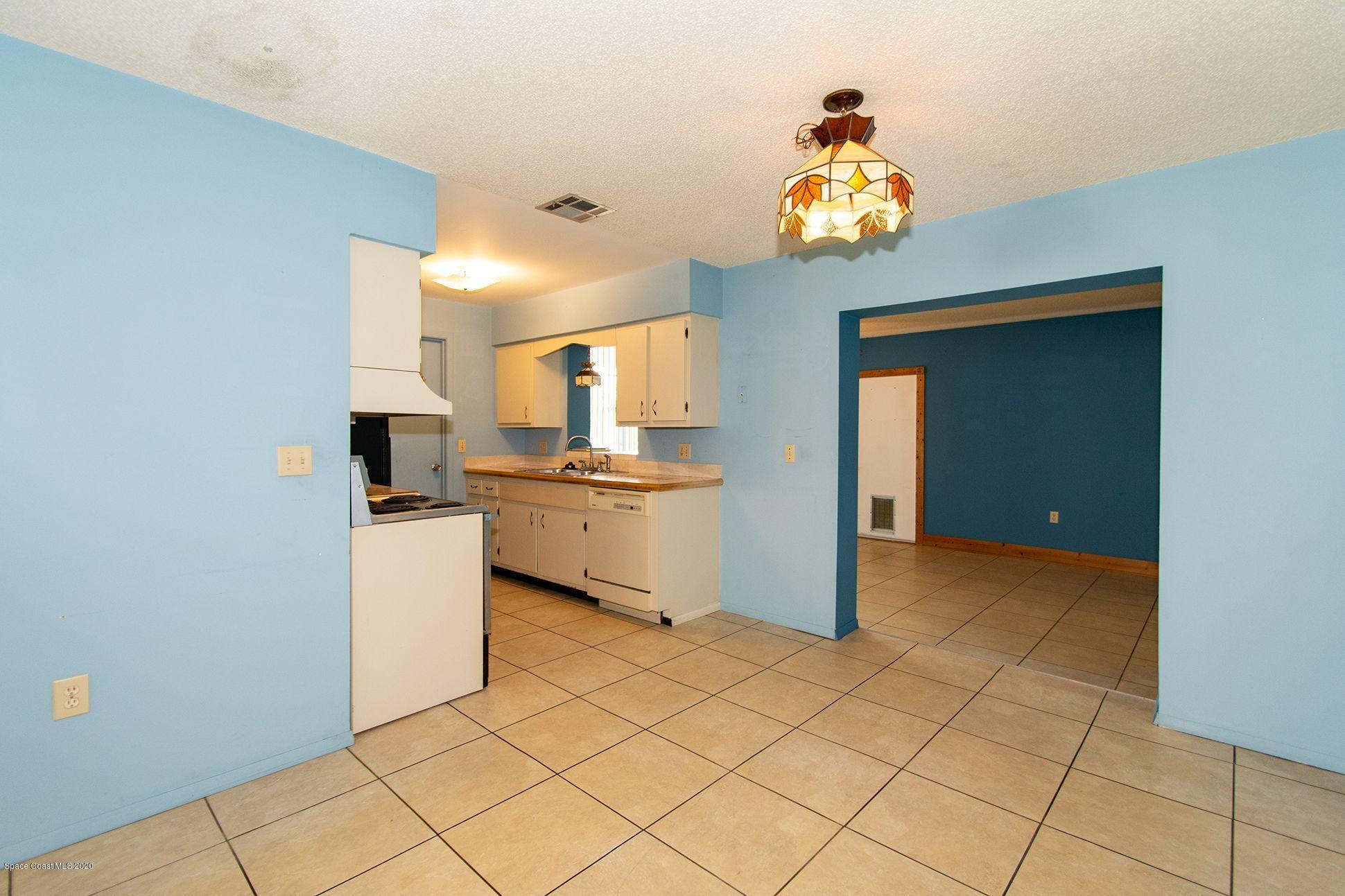 2872 Pembroke Road Melbourne, FL 32935 - Photo 10 of 32 a kitchen with stainless steel appliances a sink and a refrigerator
