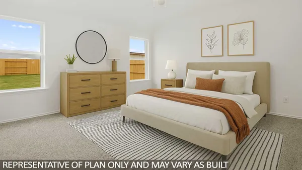 a bedroom with a bed a mirror on the dresser and a window