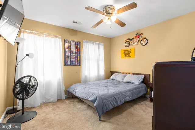 a bedroom with a bed and dresser