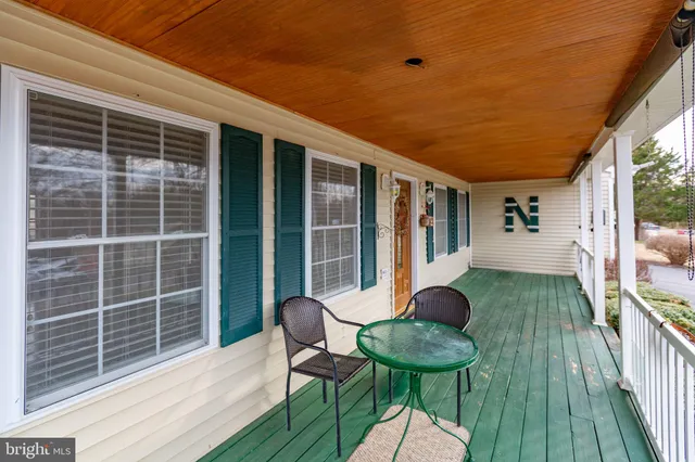 a view of a deck with table and chairs and wooden floor