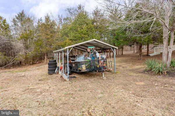 a view of a wooden deck with a trees and a barn