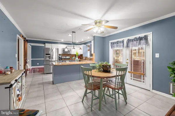 a view of a dining room with furniture and a chandelier