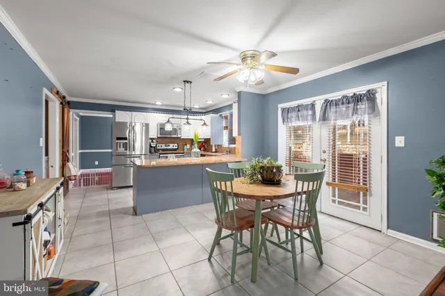 a view of a dining room with furniture and a chandelier