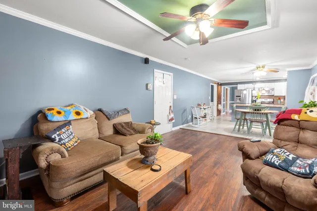 a living room with furniture and a chandelier