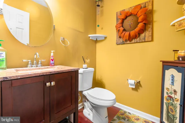 a bathroom with a sink mirror vanity and toilet