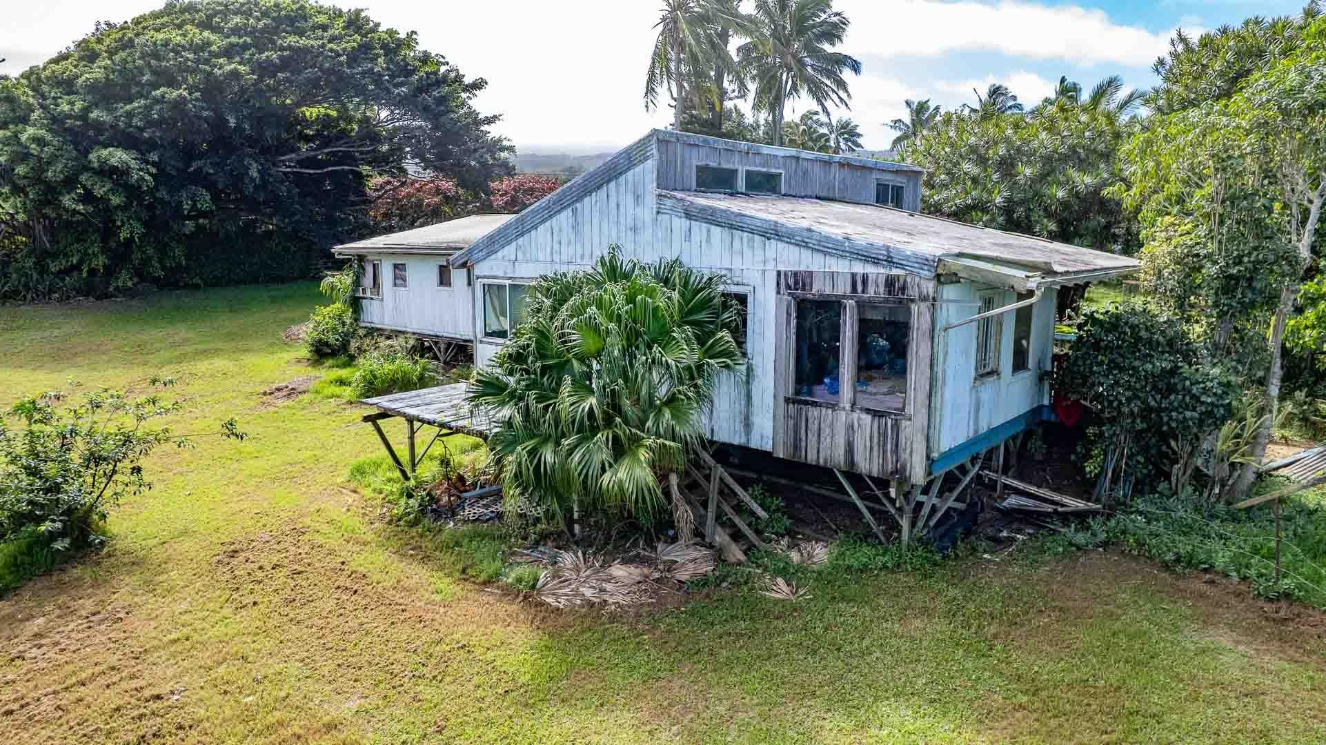 210 Door Of Faith Road Haiku, HI 96708 - Photo 30 of 44 a view of a house with a yard and a wooden deck