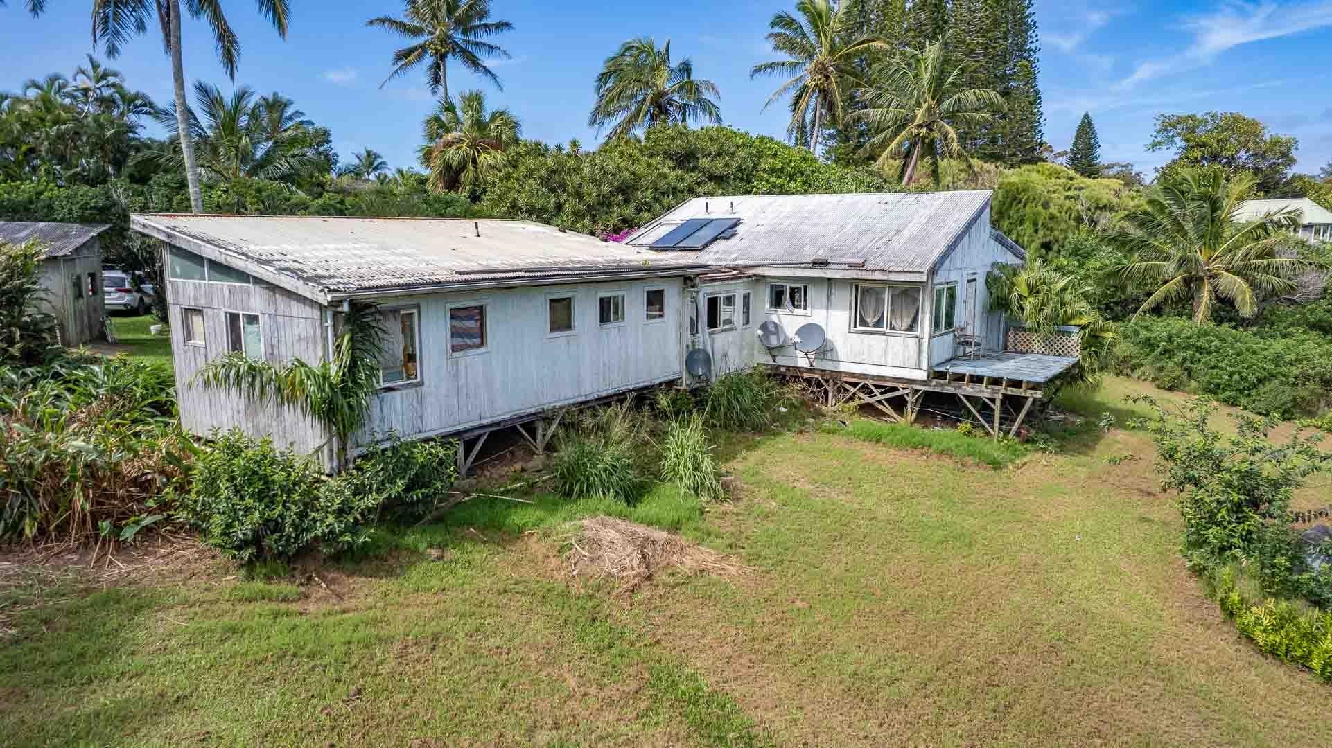 210 Door Of Faith Road Haiku, HI 96708 - Photo 33 of 44 a aerial view of a house with a yard table and chairs