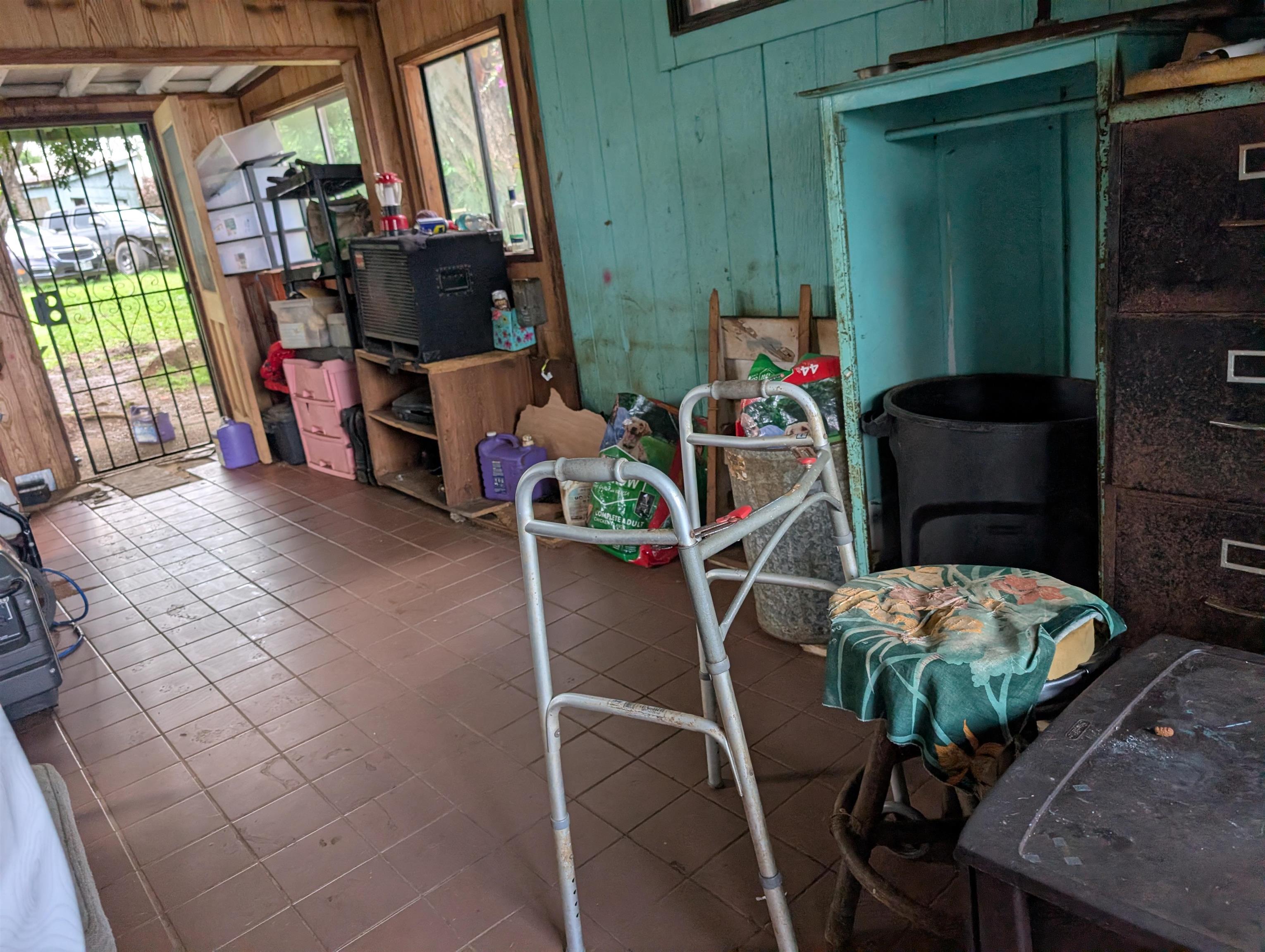 210 Door Of Faith Road Haiku, HI 96708 - Photo 42 of 44 a living room with furniture a window and a potted plant