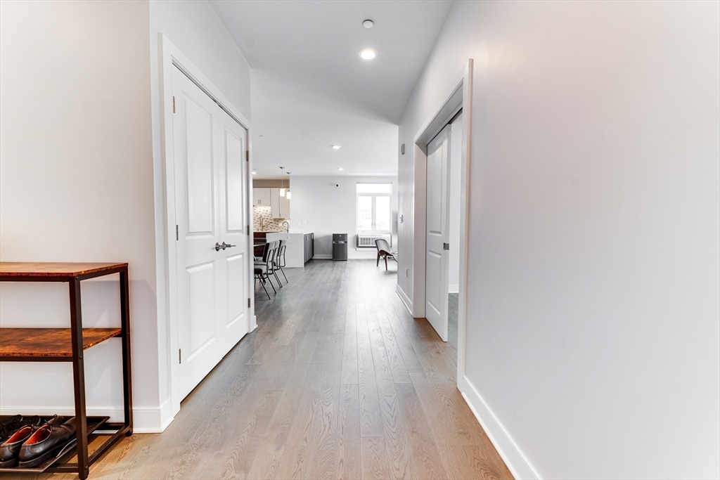2 Cliveden Street, Unit 601E Quincy, MA 02169 - Photo 13 of 27 a view of a hallway with wooden floor and a living room