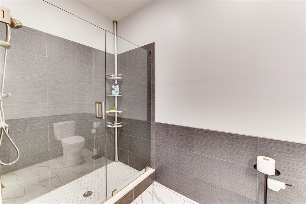2 Cliveden Street, Unit 601E Quincy, MA 02169 - Photo 18 of 27 a bathroom with a shower and toilet