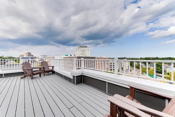 a roof deck with a table and chairs