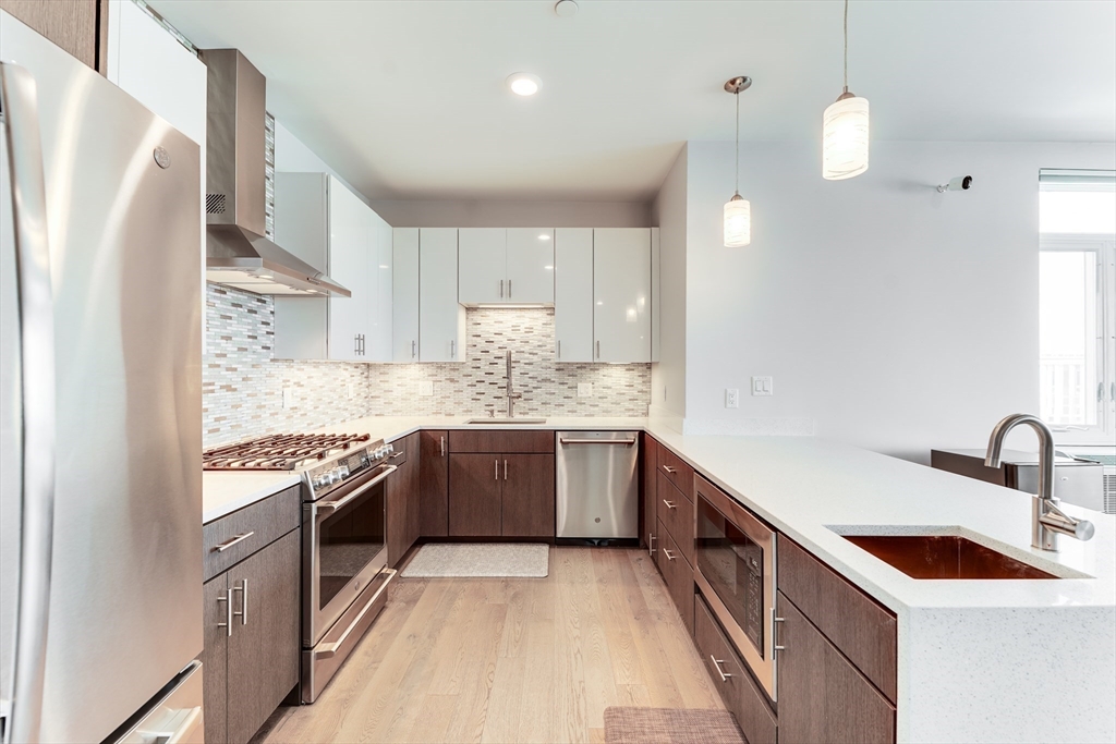 2 Cliveden Street, Unit 601E Quincy, MA 02169 - Photo 8 of 27 a kitchen with stainless steel appliances granite countertop a sink stove and refrigerator